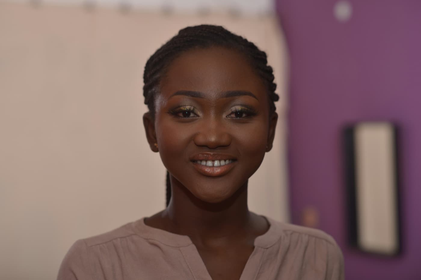 A smiling young woman with neatly braided hair in Accra, Ghana